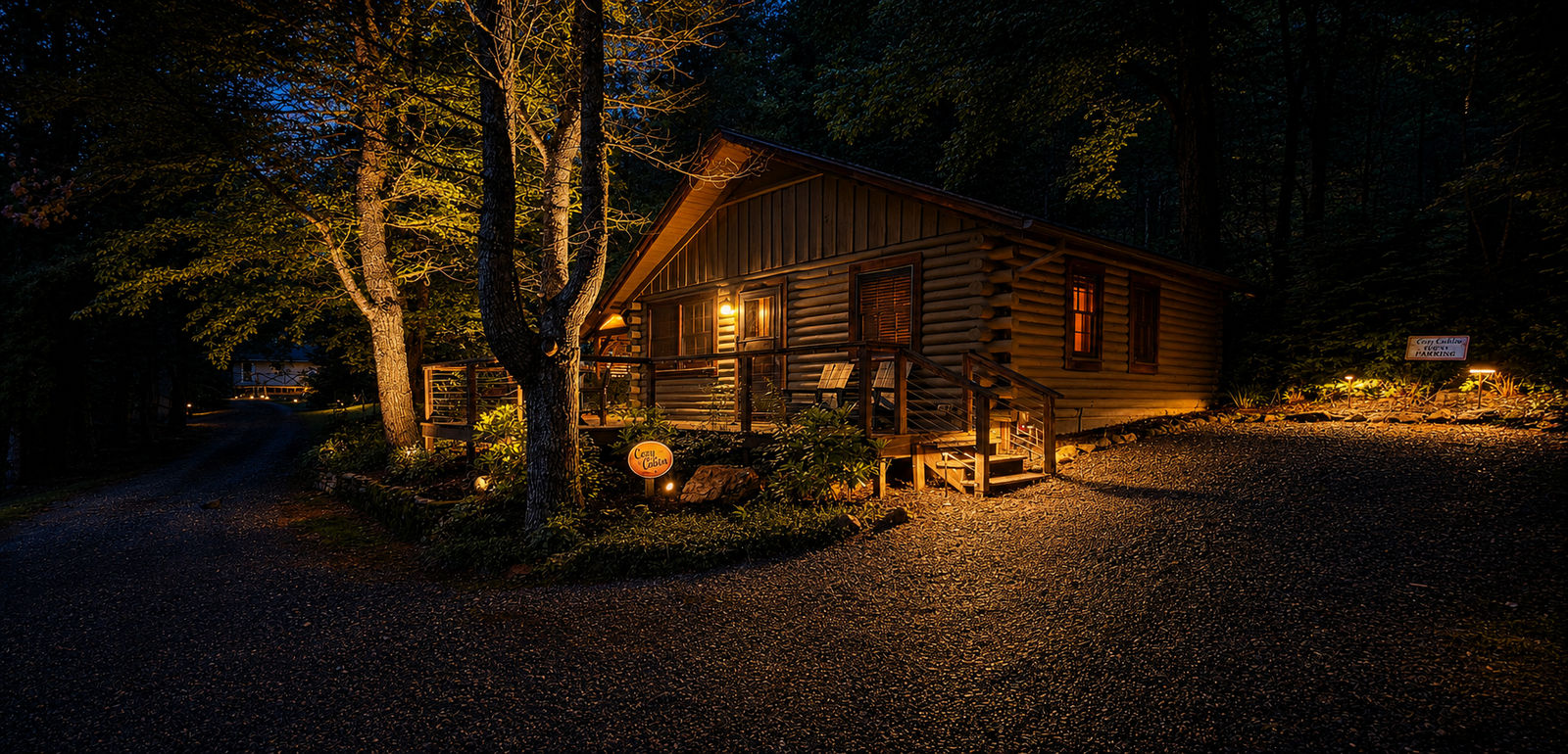 Warm architectural lighting and illuminated trees at a woodland cabin