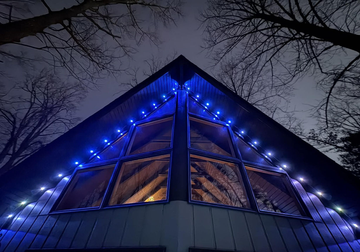 Blue and white accent lighting along a steep roofline